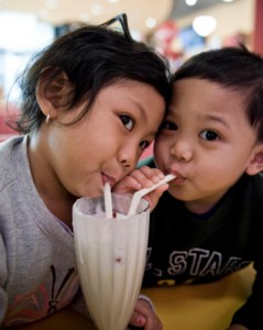 children-sharing-milkshake